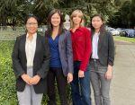 A group photo of the four members of the Berkeley International Office Frontline Team in front of a UC Berkeley sign