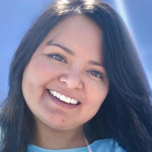 Headshot of smiling person with long dark hair.